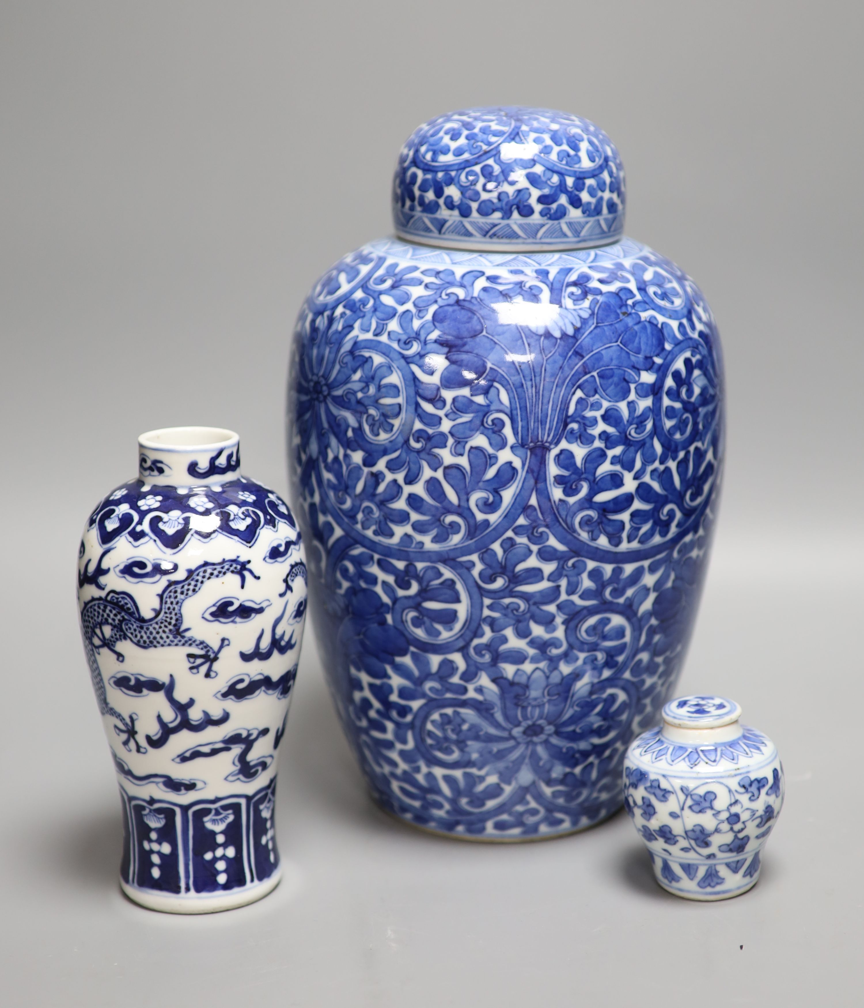 A Chinese blue and white lotus jar and cover, early 20th century, a similar dragon vase and a small Kangxi jarlet and cover, talles